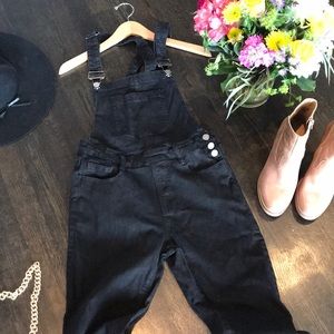 Black denim long overalls.
